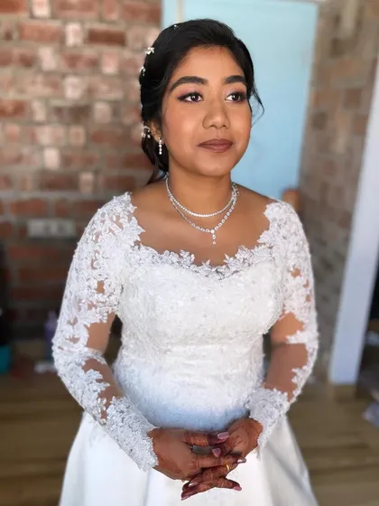 Anu in her full wedding attire. The soft, romantic makeup perfectly complements her beautiful lace gown.