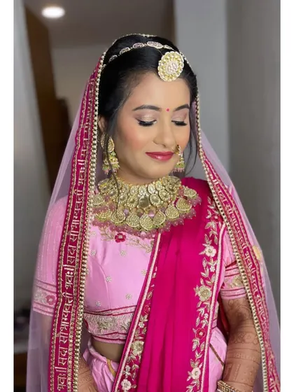 The complete bridal look with the veil. The soft makeup ensures she looks timeless and elegant, letting her beautiful smile and traditional jewelry take center stage.