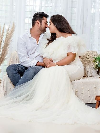 A duplicate of 70, this image perfectly captures the romance and connection of a couple's maternity shoot in a beautifully styled studio.