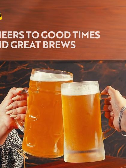 Cheers to good times and great brews at The Beer Cafe. Two large beer mugs clinking together perfectly capture the spirit of friendship and celebration that I foster.