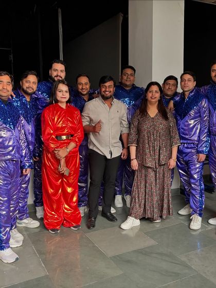A group photo with the client and performers after a successful corporate show. My goal is to ensure everyone, from the performers to the audience, has an unforgettable experience.