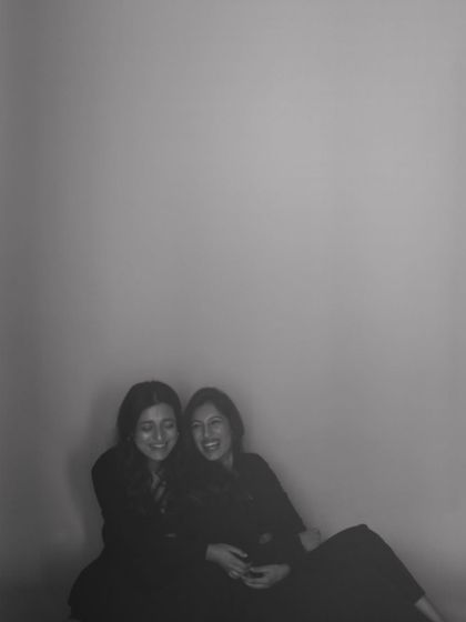 A soft, grainy photo of two friends sharing a laugh. This image feels like a cherished memory, a testament to the warmth of their bond.