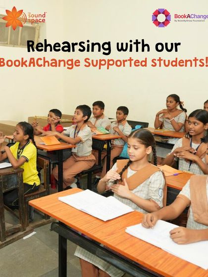 Rehearsing with our BookAChange supported students in their classroom, using hand gestures to learn a song.