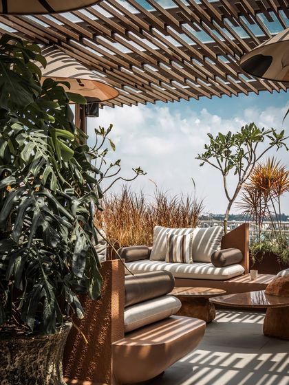 The edge of the terrace is lined with planters filled with tall grasses, creating a soft, natural barrier that doesn't obstruct the expansive city view.
