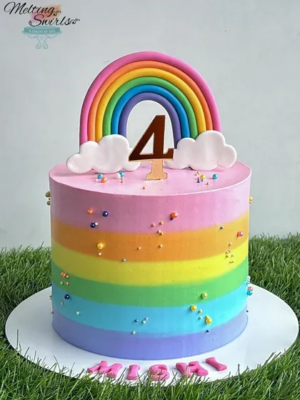 Rainbows brighten up everything! This cake features vibrant rainbow stripes on the outside and rainbow layers on the inside, all frosted with light whipped cream.