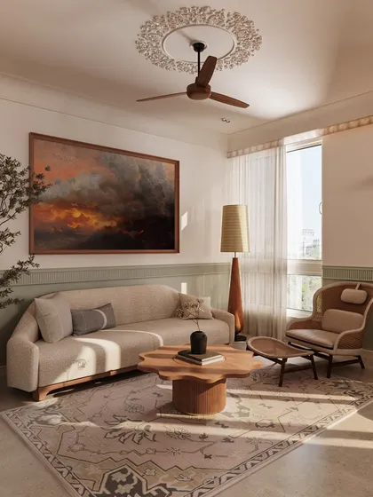 A calm and inviting living space with a two-tone wall of sage green and white. The design uses natural materials like wood and rattan, paired with a dramatic piece of art, to create a relaxed yet refined atmosphere.