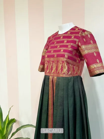 An example of our commitment to slow fashion. We transformed a client's stained vintage Kanjeevaram saree into this gorgeous, wearable dress, giving a cherished heirloom a new life.