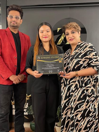 A proud moment with a graduate and one of our senior trainers.