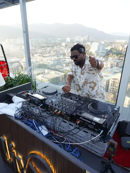 Pointing to the crowd from my DJ booth during a sundowner set. Engaging with the audience is key, even in a more relaxed setting, to make sure everyone is having a good time.