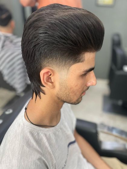 A stylish wolf cut, which is a variation of the mullet with more layers and texture. It's a very popular and trendy look right now.