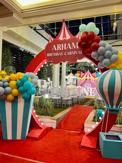 The grand entrance to Arham's birthday carnival. Guests walked through a large circus-tent-style arch, complete with a red carpet, popcorn-box props, and a hot air balloon feature.