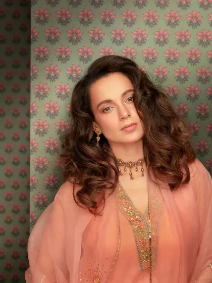 Kangana Ranaut looks absolutely elegant in this peach salwar suit from Raji Ramniq. The delicate embroidery and organza dupatta, paired with a traditional choker, create a look of timeless grace.