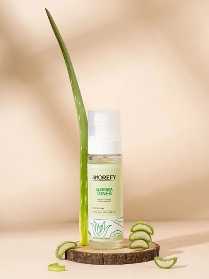 An aloe vera toner styled with a real aloe leaf and warm, sunny lighting. The use of natural light and shadows adds depth and a sense of natural goodness.