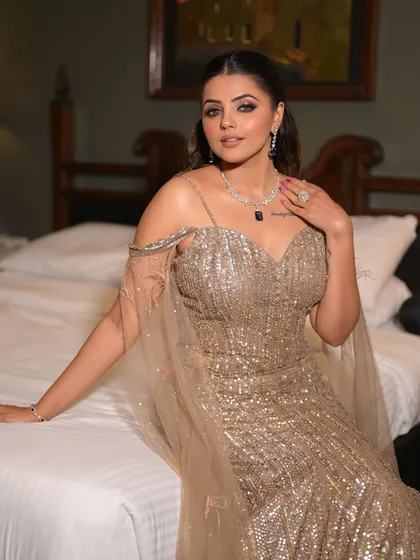 A full view of the chic cocktail look. The sequined gown is perfectly complemented by the glamorous makeup and sleek hairstyle, creating a cohesive and unforgettable look.
