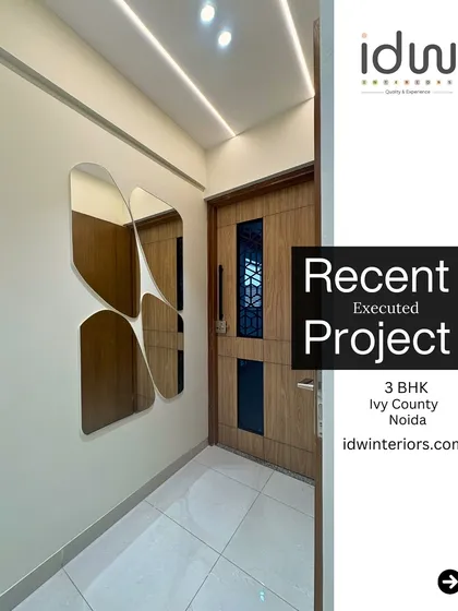 This foyer features a unique, clover-shaped mirror arrangement that serves as a piece of wall art. The design is modern, elegant, and makes the space feel larger.