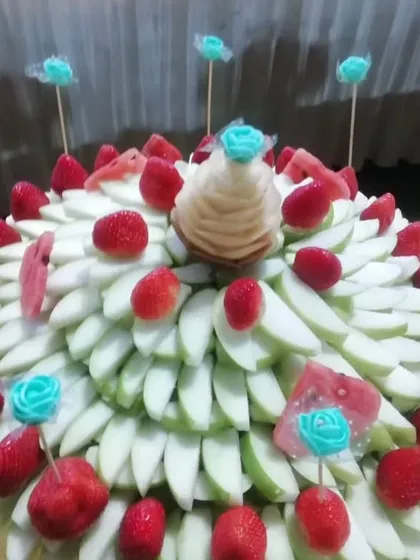 A delightful fruit platter combining fresh strawberries and sliced green apples. The arrangement is simple yet elegant, perfect for any celebration.