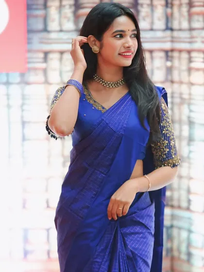 A happy client looking radiant in our royal blue saree. We paired it with a custom designed blouse featuring heavy gold sequin work on the sleeves, making it a perfect outfit for an evening event or reception.