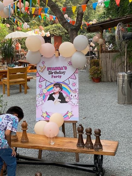A personalized welcome sign for a unicorn-themed party at an outdoor venue.