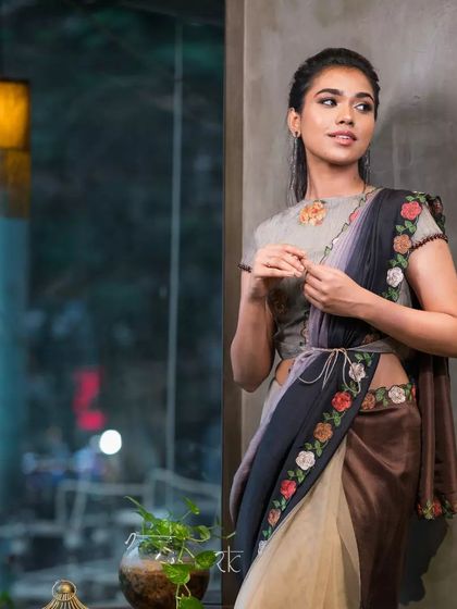 The full look showcases a modern and sophisticated way to wear a saree, with its unique color blocking and belted style.