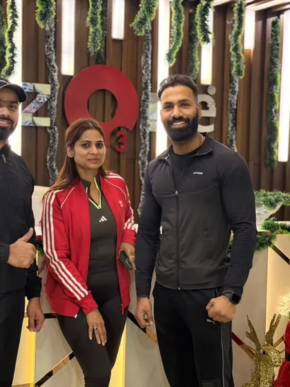 Members and a trainer smiling for a photo during the holiday season. The festive vibes bring our elite tribe even closer together.