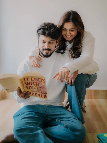Another angle from their reading session. Her pointing at the book creates an interactive and engaging moment, showing them sharing a common interest.