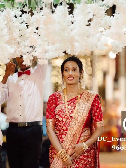 A beautiful bridal entry moment, featuring a delicate floral canopy held by attendants. We help coordinate these special moments to ensure they are as beautiful as they are meaningful.