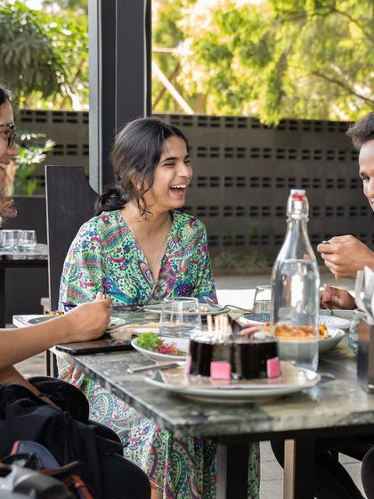 A birthday celebration in full swing. Sharing cake and laughter with friends is what it's all about.