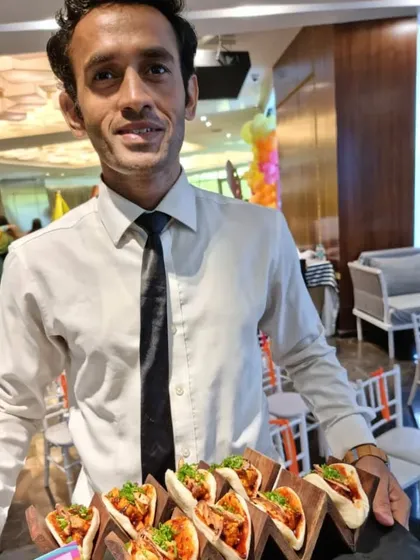 One of our friendly staff members serving up delicious mini tacos. We ensure the service at kids' parties is just as professional and warm as at any of our other events.