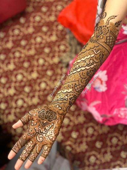 A full arm view of Afnaz's Pakistani bridal henna, showing the diagonal flow of the intricate patterns.