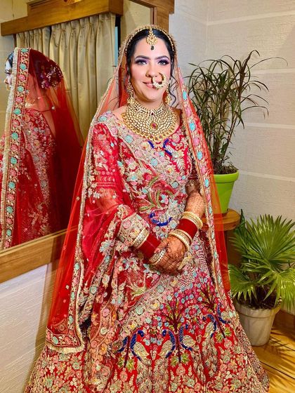 The full bridal look, complete with a stunningly detailed lehenga with peacock embroidery. The makeup enhances her features without overpowering the outfit.
