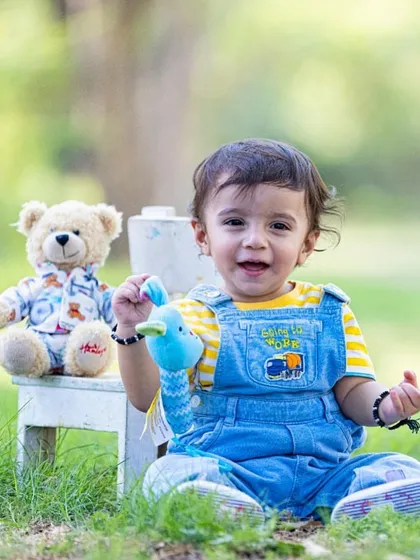 A classic portrait with his best friends. Including a child's favorite toys can make them feel comfortable and adds a personal touch to the photos.