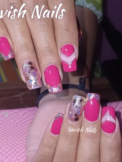 Bright pink square nails get a fun twist with chunky glitter accent nails and a modern geometric design.