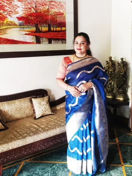 Ethereal elegance in every drape. Our client radiates grace in this stunning blue organza silk saree.