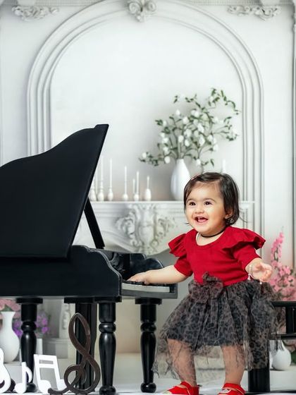 You may hold my hand for a while, but you hold my heart forever. A joyful, candid moment of a girl dancing at the piano.