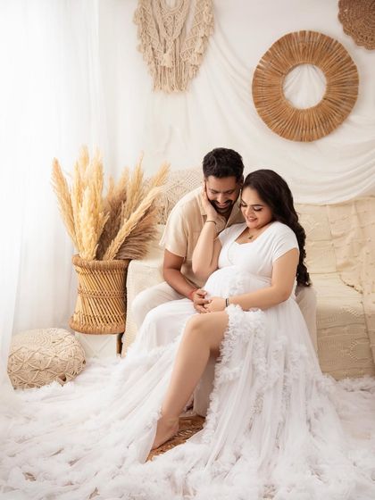 A playful and tender moment. Capturing these natural interactions is what makes a couple's maternity session so special.