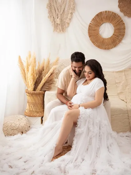 A playful and tender moment. Capturing these natural interactions is what makes a couple's maternity session so special.