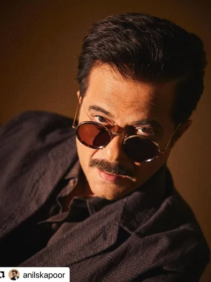 A playful peek over the sunglasses. The hair is styled with a bit more of a relaxed feel here.