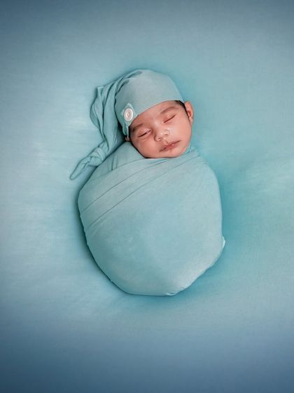 As snug as can be. This simple, minimalist photo of a baby swaddled in blue is a testament to the beauty of keeping things pure and focused.