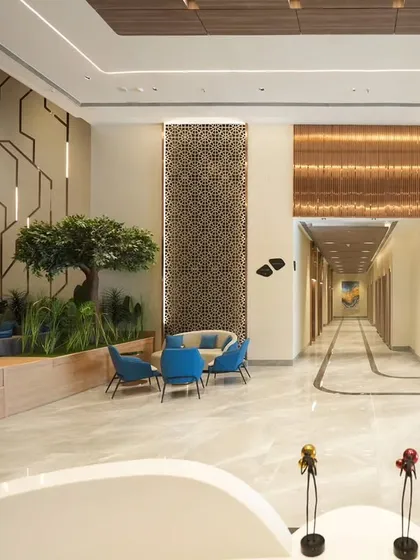 Capturing the scale of this expansive corporate lobby for Architect Reza Kabul required a composition that shows both its depth and its design elements. This triptych-style image displays the long hallway, the comfortable seating areas, and intricate wall panels, giving a full sense of the impressive space.