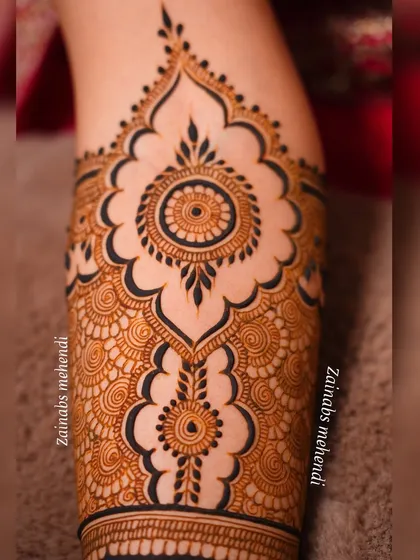Another detailed shot of Arsha's forearm, showing the repeating mandala pattern.