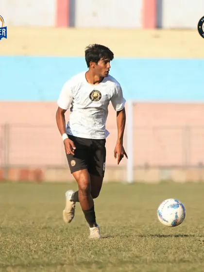 A player on the run, focused on the ball and the game ahead.