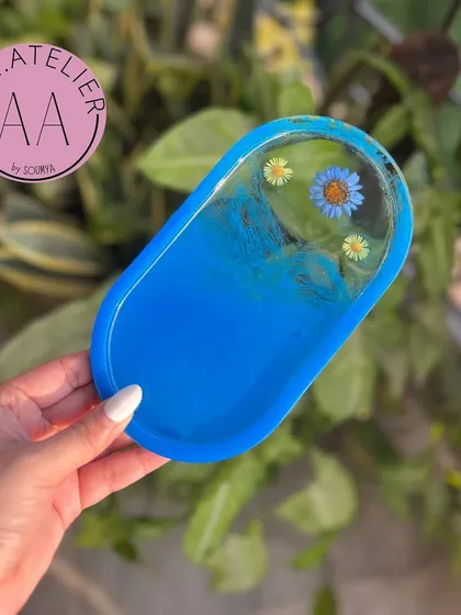 A bright blue oval trinket tray. These are great for keeping your washroom counter or office desk organized while adding a splash of color.
