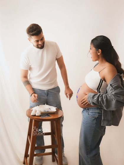 A candid moment looking at baby clothes and a sonogram. Including these little details makes the maternity session even more personal and memorable.