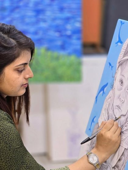 An artist's focus is key. This image shows a student concentrating on the fine details of her ballpoint pen portrait.