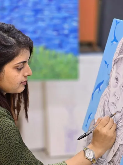 An artist's focus is key. This image shows a student concentrating on the fine details of her ballpoint pen portrait.