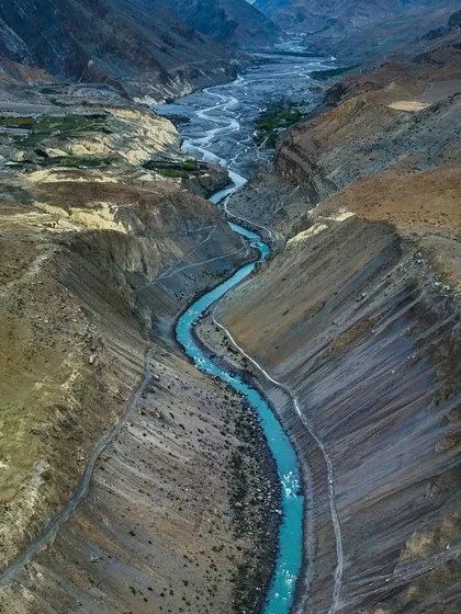 The Spiti River, a ribbon of turquoise flowing through the rugged Himalayan desert. Capturing this view required finding the perfect vantage point to show the river's journey through the vast canyon.