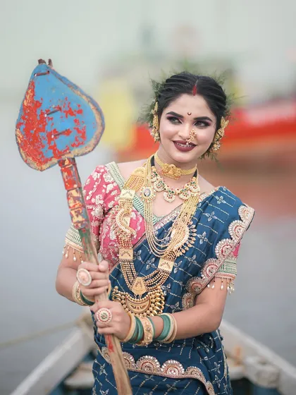 A close-up of the Koli look, showing the intricate details of the traditional gold jewellery and the unique hairstyle.