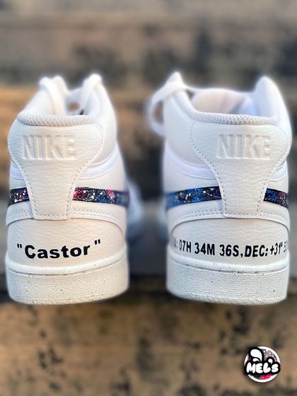 A close-up of the personalized heels on the cosmic high-tops, featuring the name "Castor" and unique coordinates.