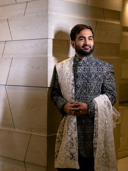 A stylish portrait of the groom in his intricately designed bandhgala, looking sharp for the Roka ceremony.