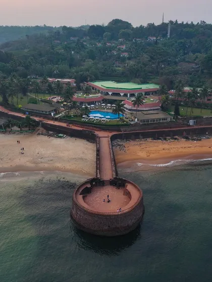 The Sinquerim Fort in Goa, extending into the sea. This 17th-century fort offers a stunning vantage point, and from the air, its unique circular structure is even more impressive.